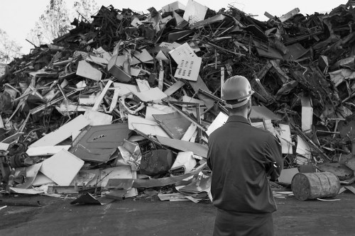 Professional team loading a grab hire container with construction debris